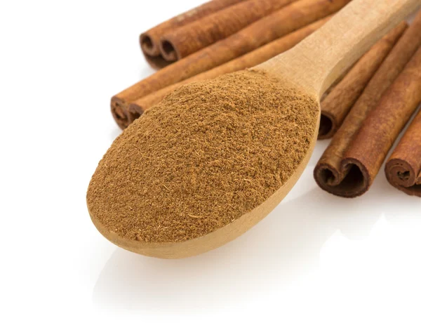 Cinnamon in spoon on white — Stock Photo, Image
