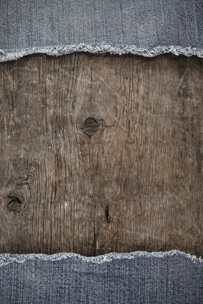 Blue jean on wood texture — Stock Photo, Image