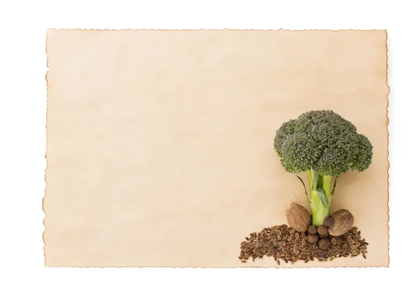 Broccoli and spices on old paper — Stock Photo, Image