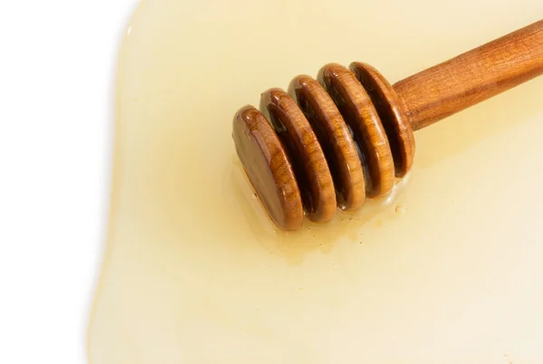 Мед и палку на белом — стоковое фото