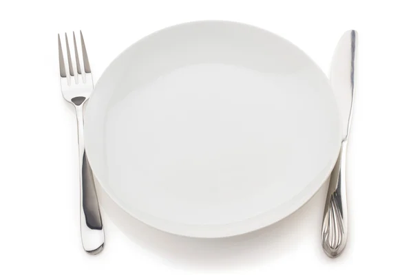 Plate, knife and fork on white — Stock Photo, Image