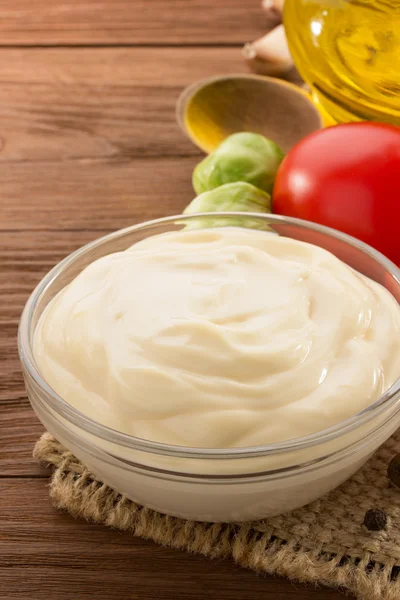 Mayonnaise sauce in bowl on wood — Stock Photo, Image