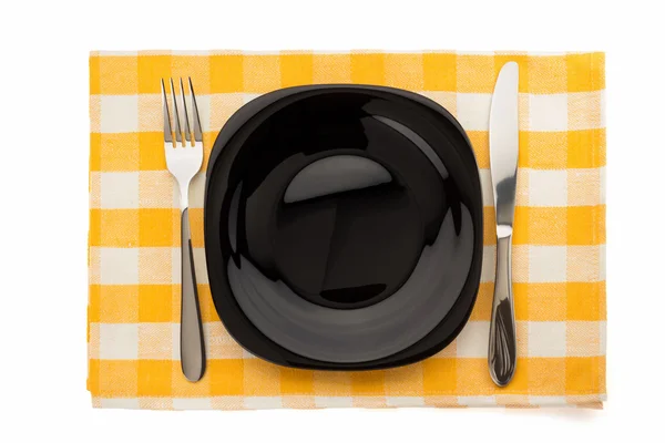 Plate, knife and fork at napkin — Stock Photo, Image