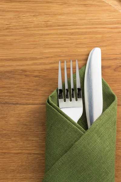 Knife and fork at napkin — Stock Photo, Image