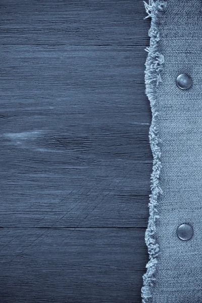 Blue jean on wood texture — Stock Photo, Image