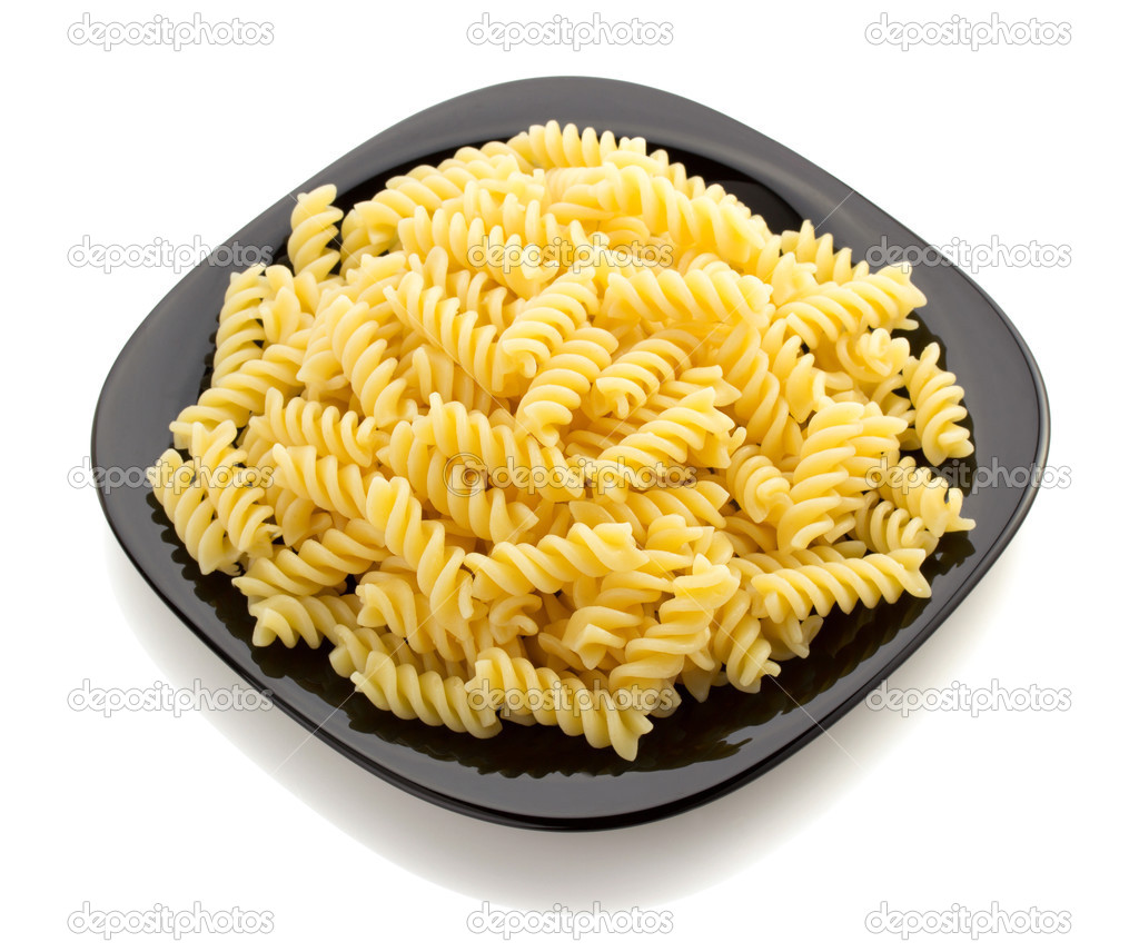 pasta fusilli in plate on white
