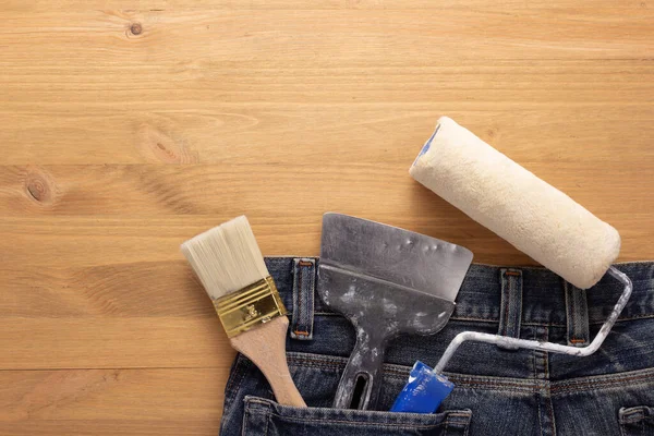 Kit Paint Tools Jeans Pocket Wooden Table Background House Renovation — Stock Photo, Image