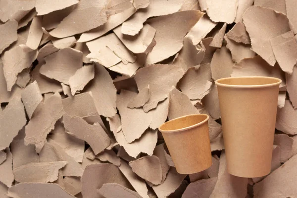 Coffee cup and waste paper background texture. Recycling concept  and brown cardboard heap
