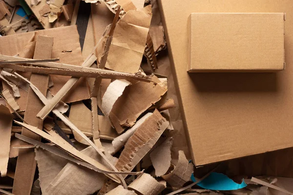 Waste paper and cardboard box background texture. Recycling concept and brown cardboard heap