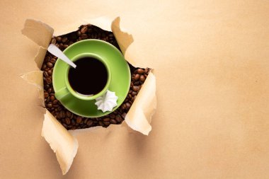 Cup of coffee and beans in paper background. Relax coffee concept