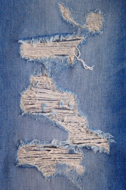 Kotun yırtık arka plan dokusu. Mavi Kot kumaş kumaş malzeme yüzeyi olarak