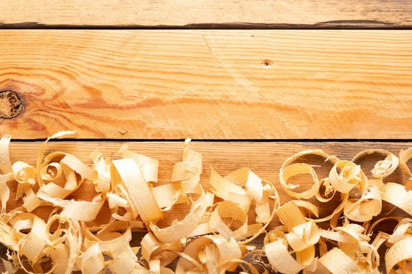 Wood shavings on table or floor background. Wooden shaving at old plank board texture