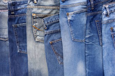 Heap of torn jeans denim as background texture. Blue jeans fabric material surface