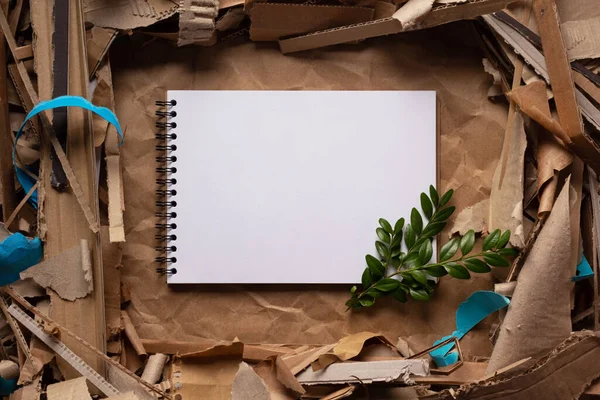 Waste paper and notebook as background texture. Recycling concept and brown cardboard heap