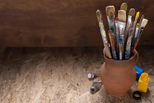 Paint brush and tools at table background texture. Paintbrush for painting as artistic paint still life. Abstract art concept
