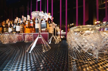 Martini glasses on the background of bottles