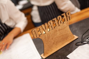 Table with the inscription reserved. Booking your seat.
