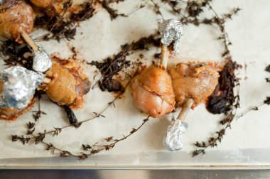 Cook preparing chicken confit leg.