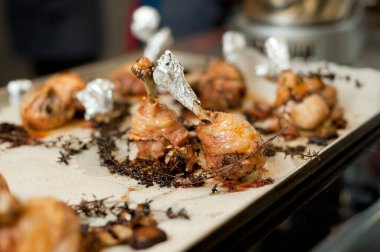 Cook preparing chicken confit leg.