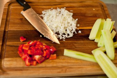The cook cuts vegetables with a knife to prepare the dish. Cutting vegetables.