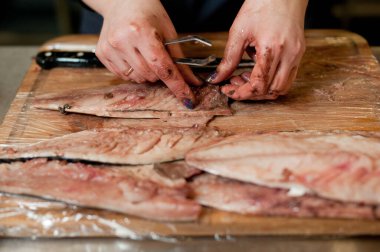 The cook separates the fillet from the fish and clears it from the bones. Mackerel fillets.