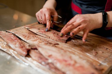 The cook separates the fillet from the fish and clears it from the bones. Mackerel fillets.
