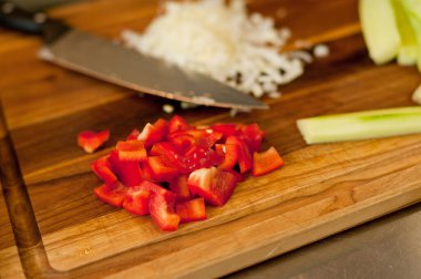 The cook cuts vegetables with a knife to prepare the dish. Cutting vegetables.