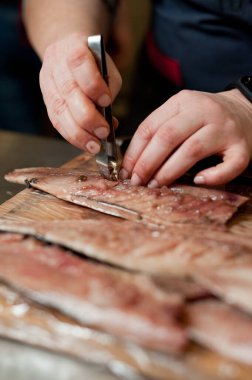 The cook separates the fillet from the fish and clears it from the bones. Mackerel fillets.