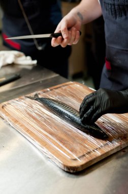 The cook separates the fillet from the fish and clears it from the bones. Mackerel fillets.