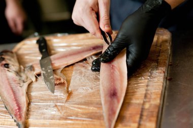 The cook separates the fillet from the fish and clears it from the bones. Mackerel fillets.