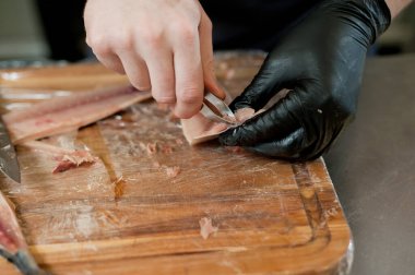 The cook separates the fillet from the fish and clears it from the bones. Mackerel fillets.