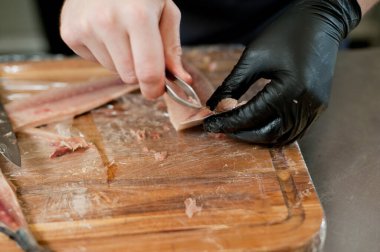 The cook separates the fillet from the fish and clears it from the bones. Mackerel fillets.