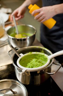 Cook cooks mashed peas.