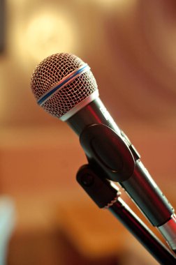 A concert microphone standing on a stand.