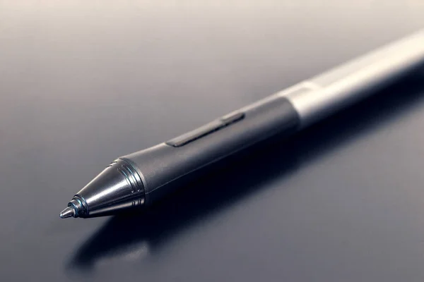 Tablet pen, stylus, lying on the surface of the tablet, close-up