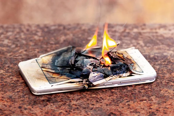 Mobile phone, smartphone, on fire. Burning smartphone