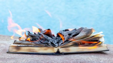 The book is on fire. Burning unnecessary, forbidden books clipart
