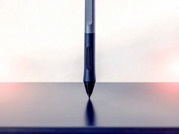 Graphic tablet and pen, stylus, with stand on a light background