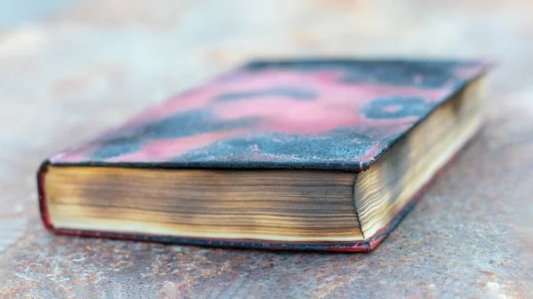 The book on the table was burnt. Book after the fire