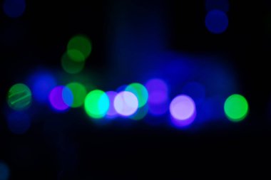 Bokeh on a dark background in cold tones, abstract bokeh background