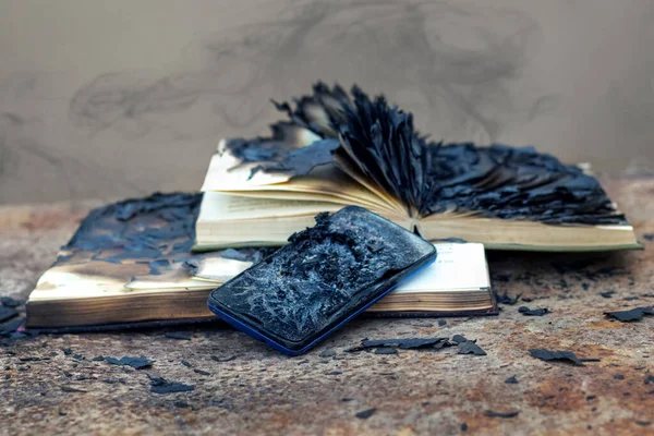 Charred books and a mobile phone after the fire. Careless handling of fire