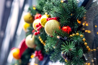 Christmas and New Year decor with bright toys and decorations on a Christmas tree branch