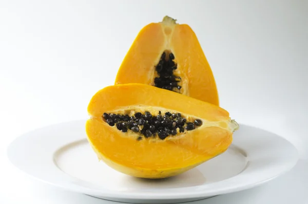 Pawpaw or Papaya isolated on a white plate — Stock Photo, Image