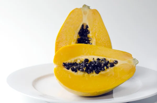 Pawpaw or Papaya isolated on a white plate — Stock Photo, Image