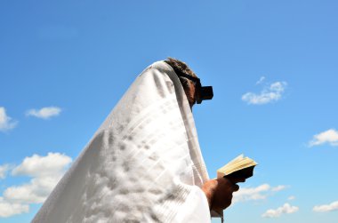 Yahudi adam dua Allah'a açık mavi gökyüzü altında