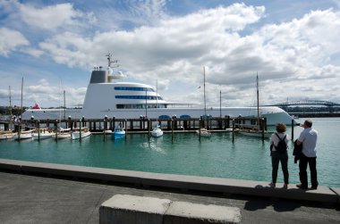 Luxury motor yacht mooring at Auckland Wynyard Wharf clipart