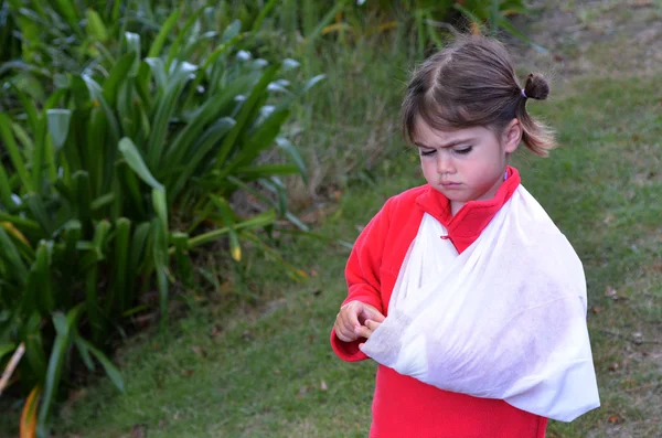 Meisje met een gebroken arm — Stockfoto