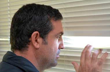 Man looking through blinds clipart