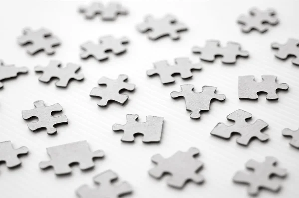 Scattered puzzle pieces — Stock Photo, Image