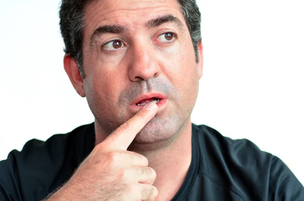 Mature man thinking with one finger on his lips — Stock Photo, Image